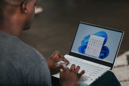Man on Windows 11 laptop with apps selection