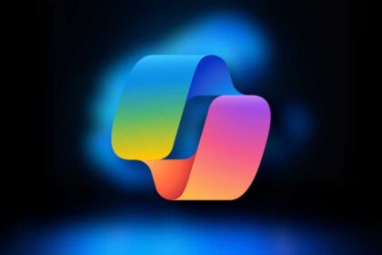 Microsoft Copilot logo on blurred Windows 11 laptop background