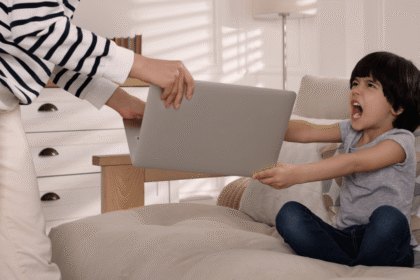 Mutter mit schreiendem Kind und Laptop